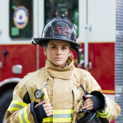 Firefighter with firetruck in background
